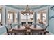 Bright dining room with water views and a rustic wooden table at 635 Key Royale Dr, Holmes Beach, FL 34217