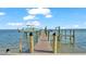 Private wooden dock with a boat lift at 635 Key Royale Dr, Holmes Beach, FL 34217