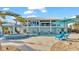 Back view of a two-story home with pool and spa at 635 Key Royale Dr, Holmes Beach, FL 34217
