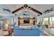 Bright living room with water view, comfortable seating and built-in shelving at 635 Key Royale Dr, Holmes Beach, FL 34217