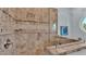 Walk-in shower with glass enclosure and stone tile at 635 Key Royale Dr, Holmes Beach, FL 34217