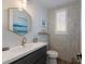 Chic powder room with geometric tile and gold accents at 6605 Gulf Dr, Holmes Beach, FL 34217