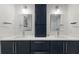 Double vanity bathroom with navy cabinets at 6605 Gulf Dr, Holmes Beach, FL 34217