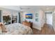Main bedroom with a king-size bed, TV, and balcony access at 6605 Gulf Dr, Holmes Beach, FL 34217