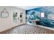 Entryway featuring a wave mural, geometric tile floor, and a wooden console table at 6605 Gulf Dr, Holmes Beach, FL 34217