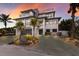 Modern coastal home with a beautiful sunset view and spacious driveway at 6605 Gulf Dr, Holmes Beach, FL 34217