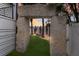 Landscaped backyard oasis with stone arch and bench at 6605 Gulf Dr, Holmes Beach, FL 34217