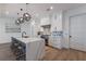Modern kitchen with white cabinets, geometric backsplash, and large island at 6605 Gulf Dr, Holmes Beach, FL 34217