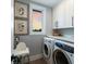 Laundry room with washer, dryer, and overhead cabinets at 6605 Gulf Dr, Holmes Beach, FL 34217