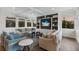 Spacious living room with comfortable seating, built-in shelving, and large windows at 6605 Gulf Dr, Holmes Beach, FL 34217