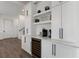 Built-in wet bar with wine cooler and white cabinetry at 6605 Gulf Dr, Holmes Beach, FL 34217