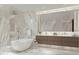 Elegant bathroom with marble finishes, soaking tub, and double vanity at 668 Quay Commons # 0705, Sarasota, FL 34236