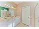 Double vanity bathroom with a large mirror at 6710 Pebble Beach Way, Lakewood Ranch, FL 34202