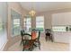 Bright breakfast nook with wood table and chairs near kitchen at 6710 Pebble Beach Way, Lakewood Ranch, FL 34202