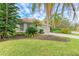 Single-Gathering house exterior with palm trees and lush landscaping at 6710 Pebble Beach Way, Lakewood Ranch, FL 34202