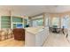 Open kitchen boasts white cabinets, breakfast bar, and adjoining living area at 6710 Pebble Beach Way, Lakewood Ranch, FL 34202