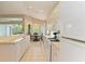 Bright kitchen features white cabinets,corian countertops and breakfast nook at 6710 Pebble Beach Way, Lakewood Ranch, FL 34202