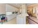 White kitchen cabinets, tile flooring, and a breakfast bar at 6710 Pebble Beach Way, Lakewood Ranch, FL 34202