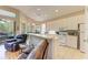 Kitchen with white cabinets, a breakfast bar, and tile floors at 6710 Pebble Beach Way, Lakewood Ranch, FL 34202
