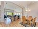 Open living room and dining area with hardwood floors at 6710 Pebble Beach Way, Lakewood Ranch, FL 34202