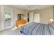 Main bedroom with king bed, private access door, and dresser at 6710 Pebble Beach Way, Lakewood Ranch, FL 34202