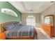 Spacious main bedroom with king bed, wood dresser and green accent wall at 6710 Pebble Beach Way, Lakewood Ranch, FL 34202