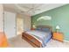 Main bedroom with king bed, private bath access, and ceiling fan at 6710 Pebble Beach Way, Lakewood Ranch, FL 34202