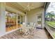 Bright screened porch with dining table and access to backyard at 6710 Pebble Beach Way, Lakewood Ranch, FL 34202