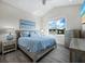 Bright bedroom with a large window, comfortable bed, and stylish nightstands at 690 Russell St, Longboat Key, FL 34228