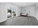 Bright entryway with white doors and gray tile floor, leading to the backyard at 690 Russell St, Longboat Key, FL 34228