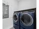 Convenient laundry room with modern stacked washer and dryer at 690 Russell St, Longboat Key, FL 34228