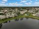 Aerial view of community, showcasing homes, landscaping, and a tranquil lake at 7146 Lakeside Dr, Sarasota, FL 34243