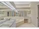 Bathroom with double vanity, corner tub and granite countertops at 7146 Lakeside Dr, Sarasota, FL 34243