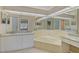 Large bathroom with double vanity, corner tub, and granite counters at 7146 Lakeside Dr, Sarasota, FL 34243