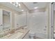 Clean bathroom with granite vanity, tub, and tiled walls at 7146 Lakeside Dr, Sarasota, FL 34243