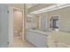 Bathroom with double vanity, shower, and tile flooring at 7146 Lakeside Dr, Sarasota, FL 34243