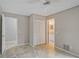 Bedroom with tile floors, a double door closet, and access to a bathroom at 7146 Lakeside Dr, Sarasota, FL 34243