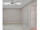 Bright bedroom featuring tile floors and a ceiling fan at 7146 Lakeside Dr, Sarasota, FL 34243