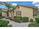 Side view of a house showcasing its light-yellow exterior and landscaping at 7146 Lakeside Dr, Sarasota, FL 34243