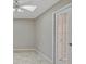 A light and airy hallway with tile flooring and a white door at 7146 Lakeside Dr, Sarasota, FL 34243