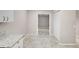 Kitchen with granite countertops, white cabinets and view of sliding door at 7146 Lakeside Dr, Sarasota, FL 34243