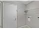 Laundry room with shelving, door and hookups for washer and dryer at 7146 Lakeside Dr, Sarasota, FL 34243