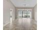 Living room with tile floors and sliding doors to patio at 7146 Lakeside Dr, Sarasota, FL 34243