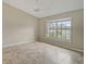 Living room with vaulted ceiling, tile floors and a large window at 7146 Lakeside Dr, Sarasota, FL 34243