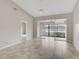 Living room with tile floors and sliding doors to patio at 7146 Lakeside Dr, Sarasota, FL 34243