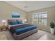 Main bedroom with king-size bed, window and water view at 7146 Lakeside Dr, Sarasota, FL 34243