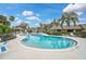 Relaxing kidney-shaped community pool with lounge chairs at 7146 Lakeside Dr, Sarasota, FL 34243