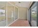 Screened patio with tile floors, sliding glass doors, and views of the backyard at 7146 Lakeside Dr, Sarasota, FL 34243