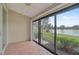 Bright screened patio with tile floors and sliding glass doors overlooking a lake at 7146 Lakeside Dr, Sarasota, FL 34243