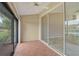 Spacious screened patio with tile floors and sliding glass doors offering multiple views at 7146 Lakeside Dr, Sarasota, FL 34243